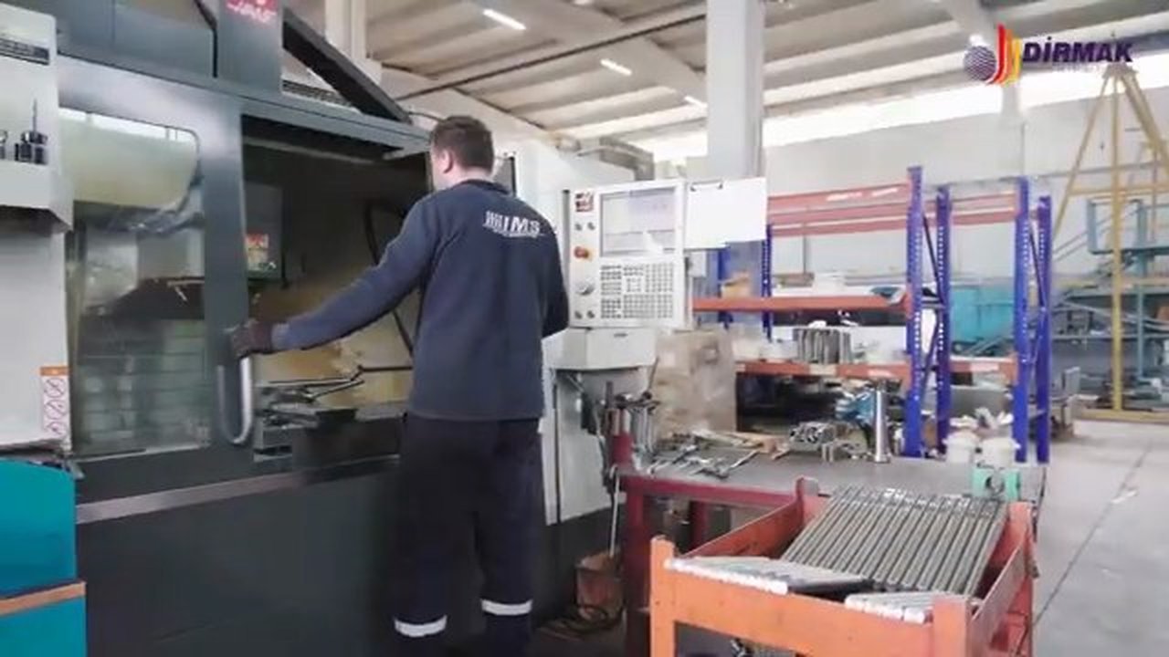 Dirmak Makina operator running a CNC machining centre — Dirmak uniform, production floor in İzmir